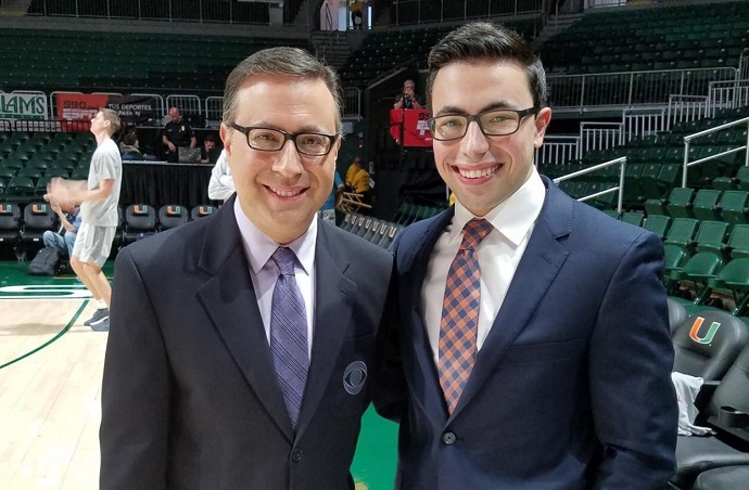 two men standing next to each other on a basketball court.