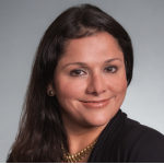 Rosalinda Vasquez Maury in front of grey backdrop