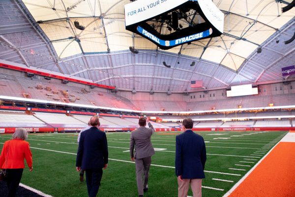 view from behind of five people touring the renovated Stadium