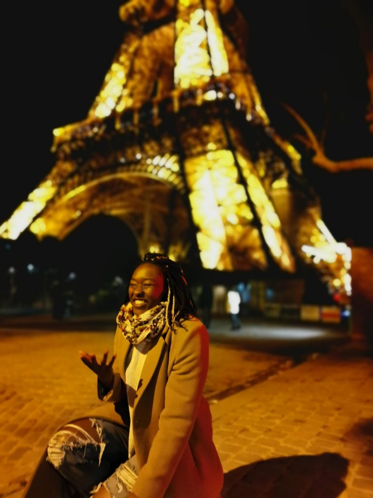 Person in front of Eiffel Tower