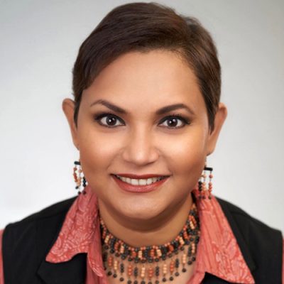 Professor Farhana Sultana looks directly into camera for profile image