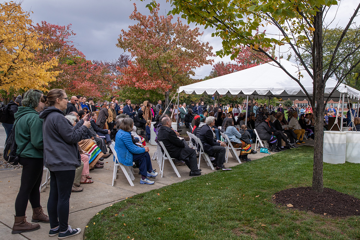 Group of people gather on the Quad for the unveiling of the Gayaneñhsä•ʔgo•nah painting on Shaw Quad