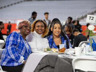 Three women enjoy traditional dinner