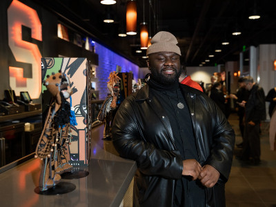 Artist Jaleel Campbell with his work