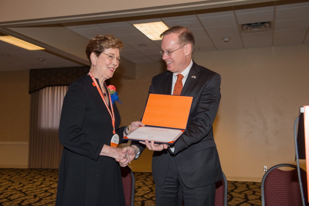 one person presenting another person with an award