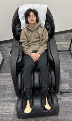 a student uses a massage chair at the MindSpa