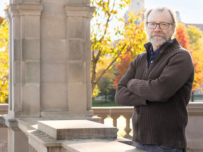 Man standing outside with his arms crossed.
