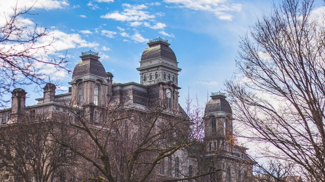 Hall of languages with a blue sky in the background and bare trees in the foreground.