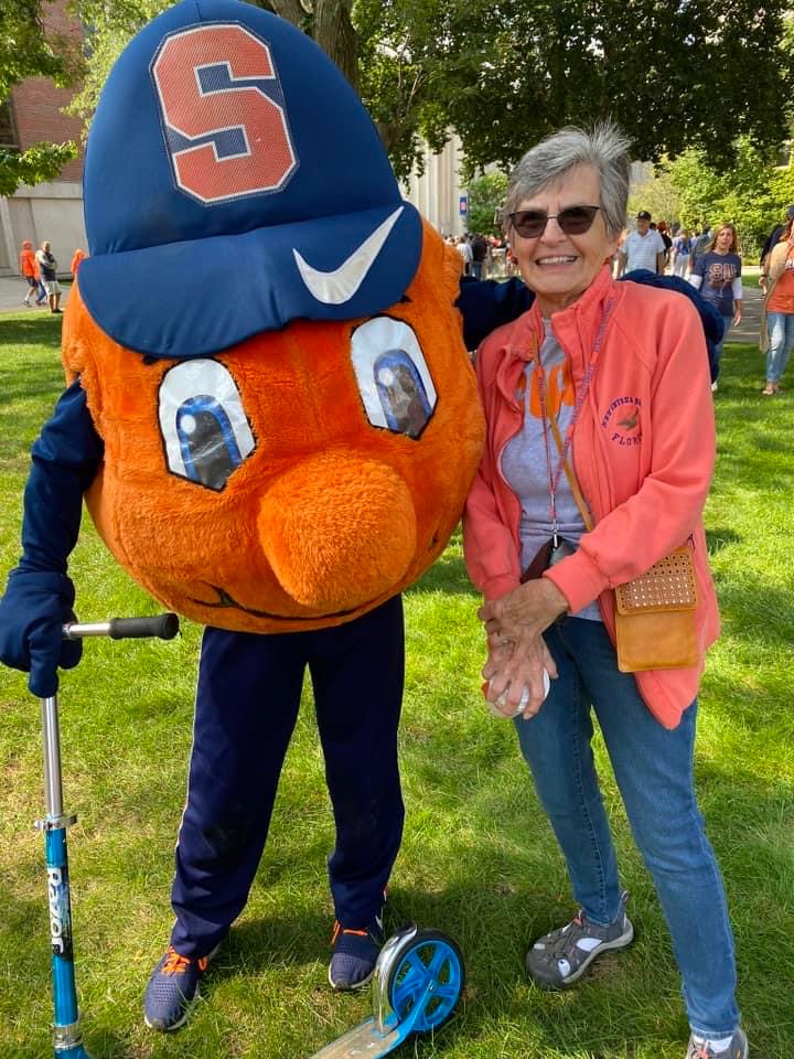 Woman standing with Otto on the Quad. 