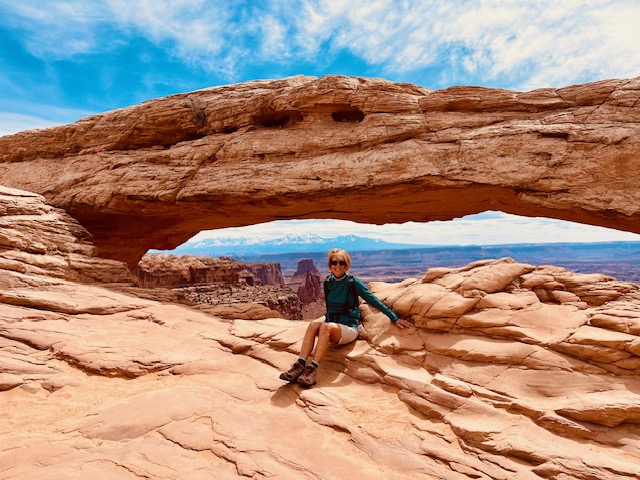 Woman sitting on mesa rocks.
