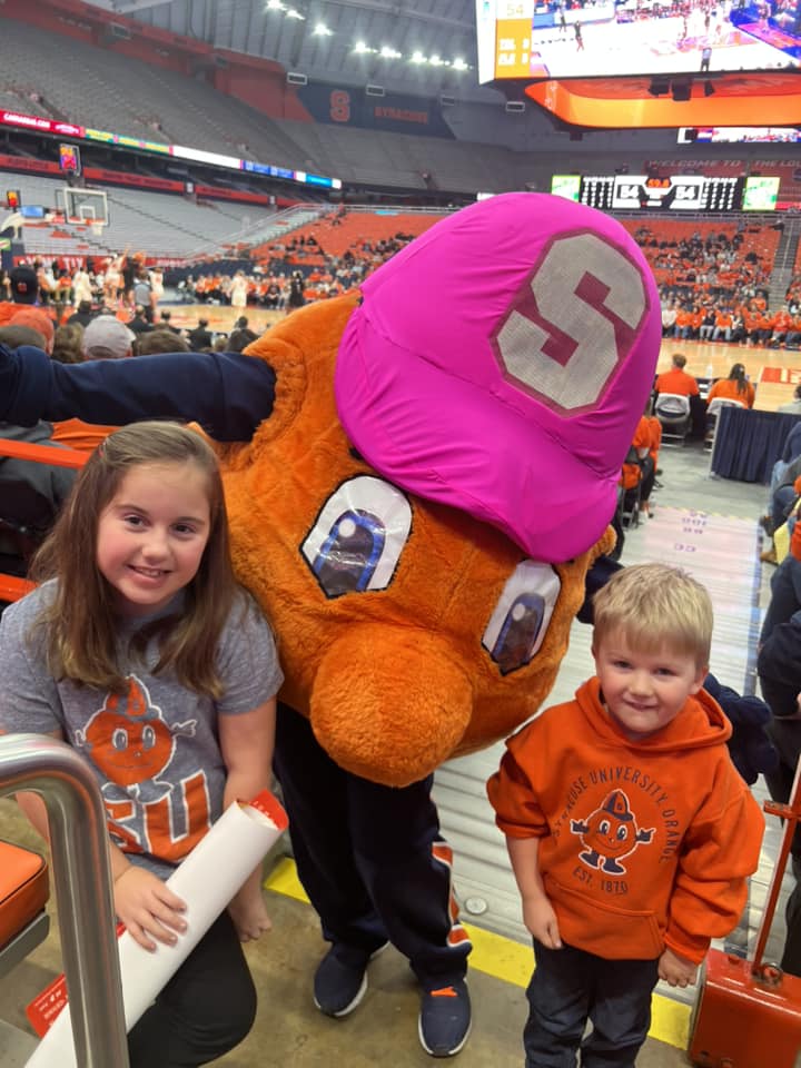 Otto with two small children at a basketball game.