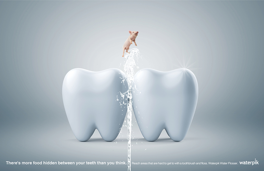 a pig getting blasted out of a giant tooth by water