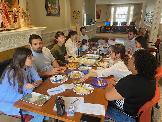 Group of people sitting around a table sharing a meal and conversation.