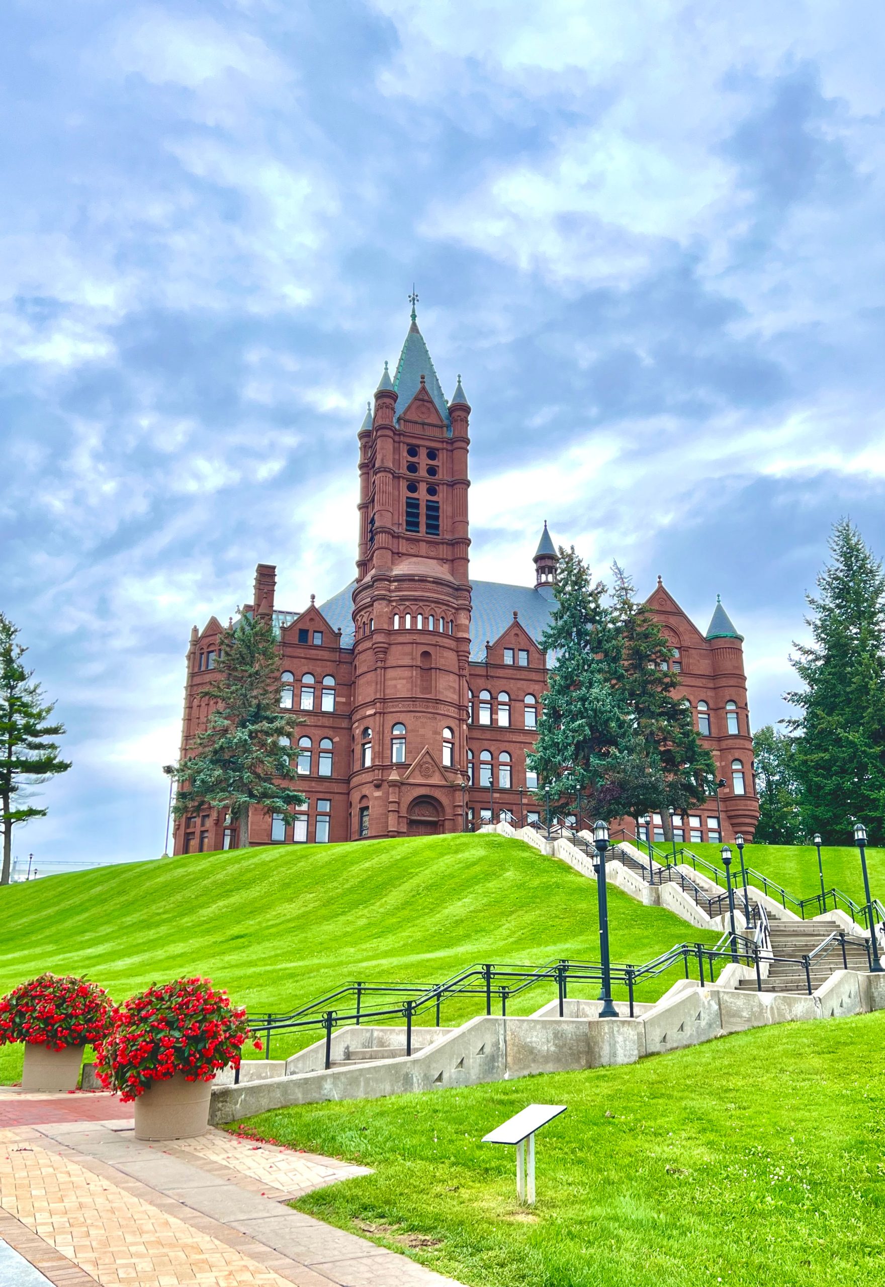 Crouse college and stairs in front of it on a cloudy day.