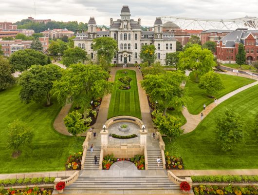 Aerial view of the Hall of Languages and the grassy area and side walks leading down to the Remembrance Wall and stairs to Promenade.
