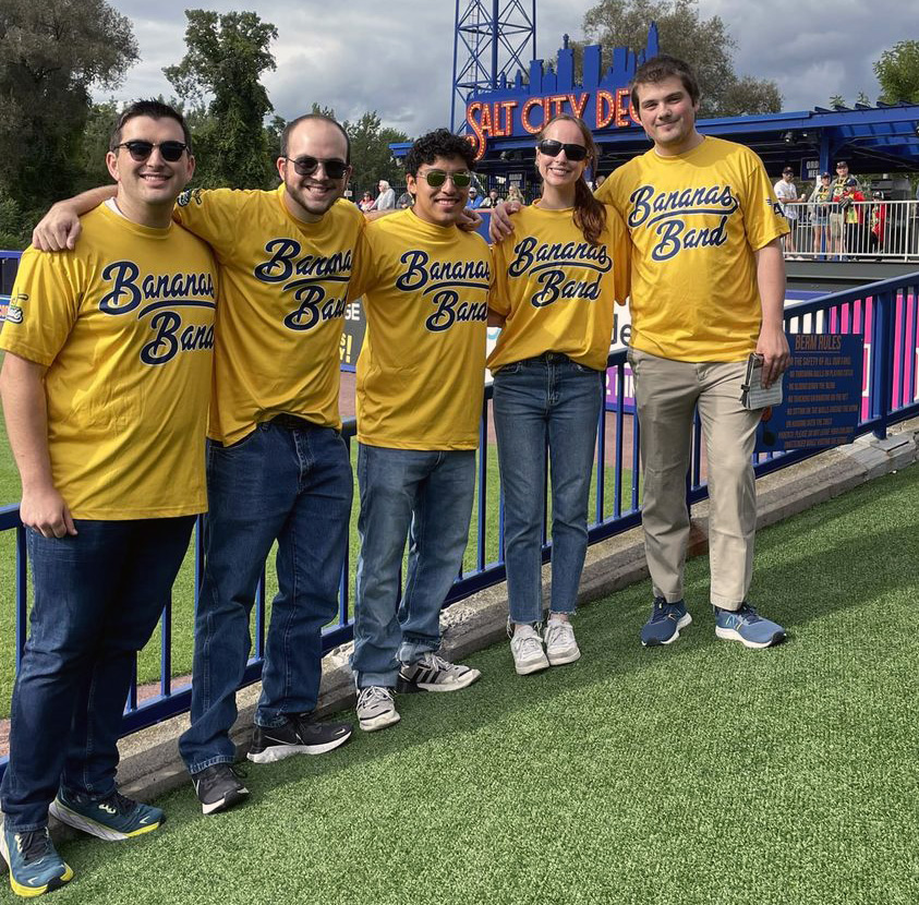 five students from SU marching bands wearing Bananas Band T-shirts at NBT Bank Stadium