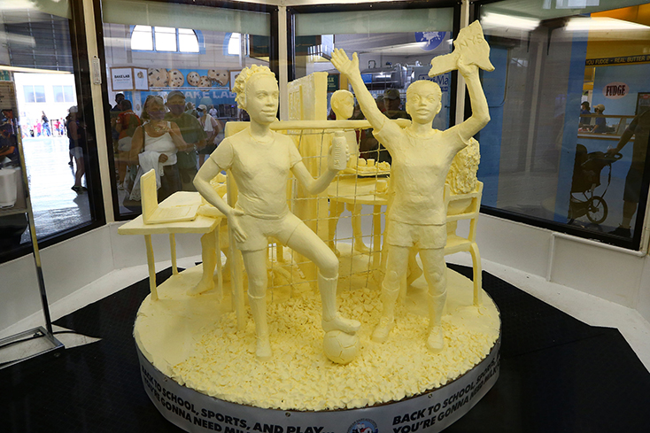 Butter sculpture of little kids playing.