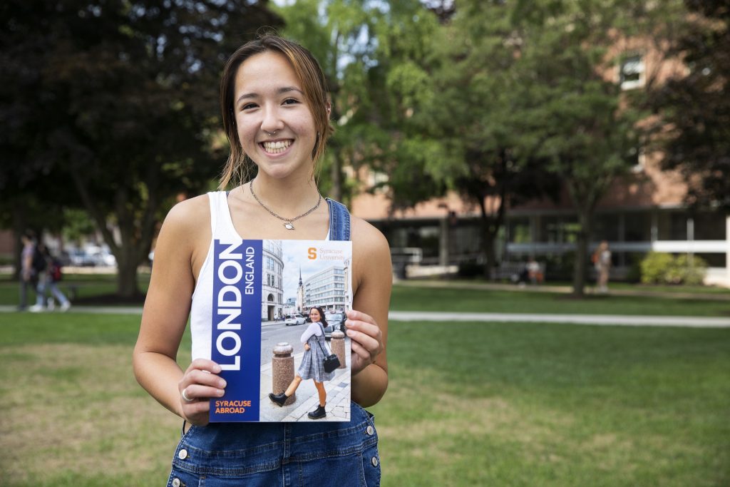person holding pamphlet on the Quad