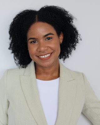 portrait of Kirsis A. Dipre against a neutral backdrop