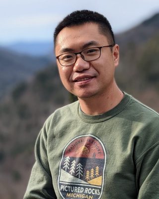 portrait of Peitao Zhu in an outdoor setting