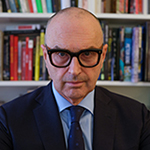 Portrait of man in front of bookshelf