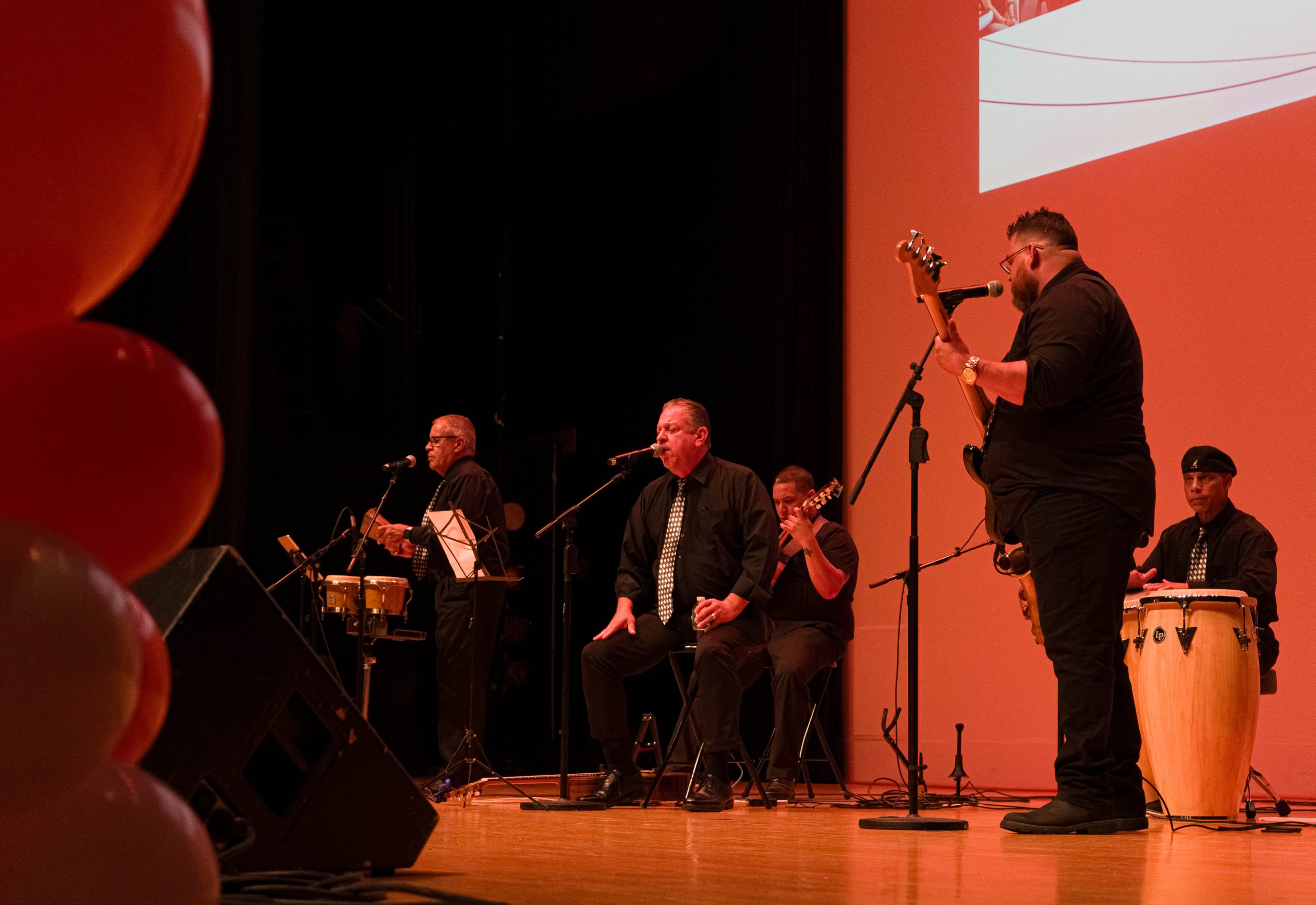 A band playing musical instruments on a stage.