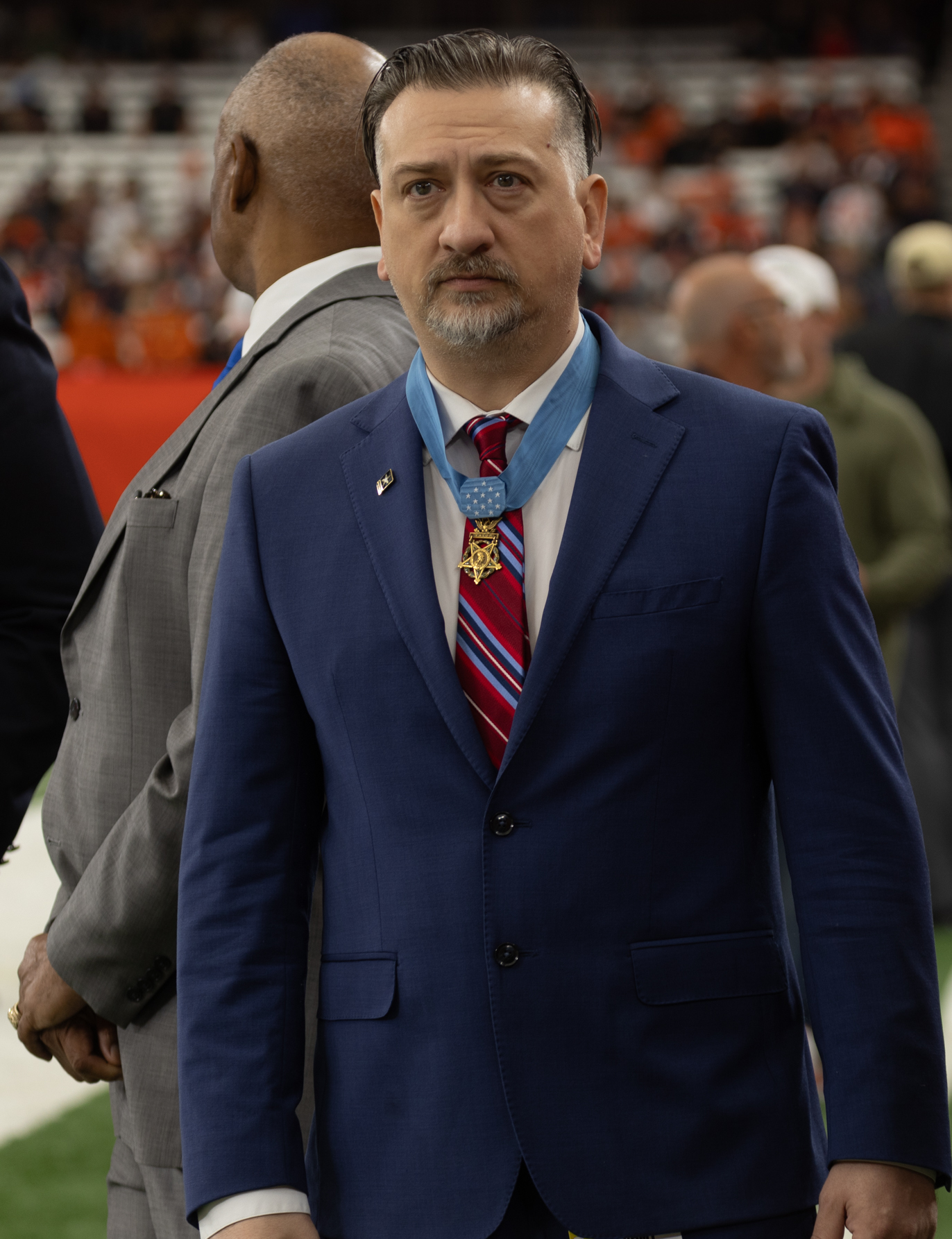 Man standing wearing a medal.