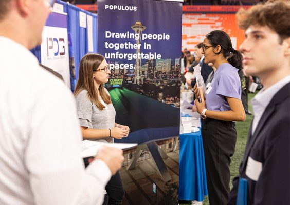 students speaking with recruiters at a campus career fair