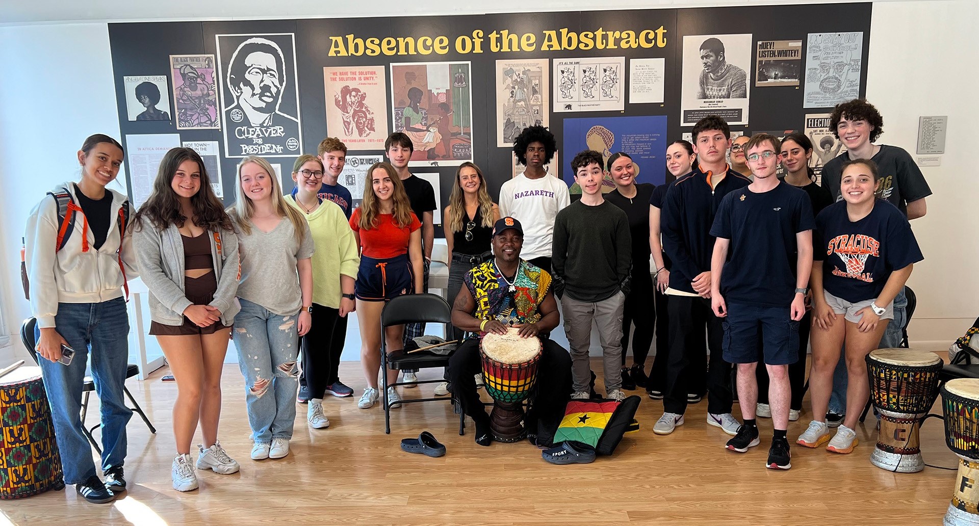 A group of students pose with a drummer