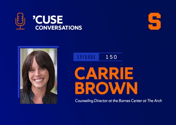 A woman smiles while posing for a photo. In the background is the Orange block S Syracuse University logo and the Cuse Conversations logo, along with the text Carrie Brown, counseling director, Barnes Center at the Arch.