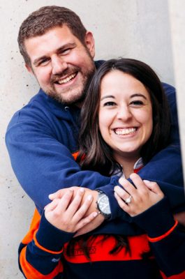 A husband and wife pose for a photo outside of the JMA Wireless Dome.