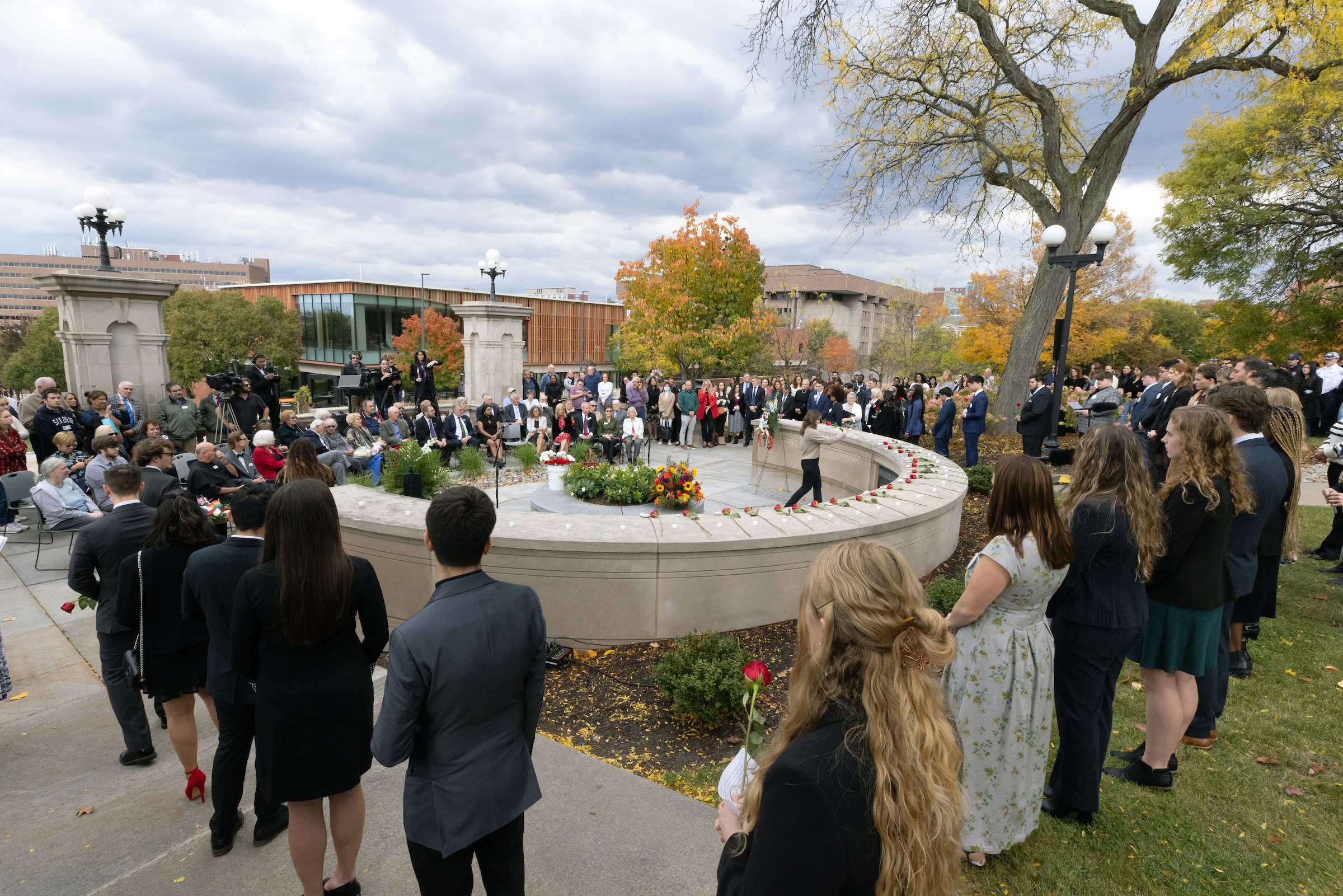 people gathered around the Remembrance Wall