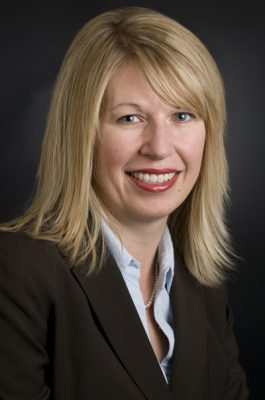 A woman smiles while posing for a headshot.