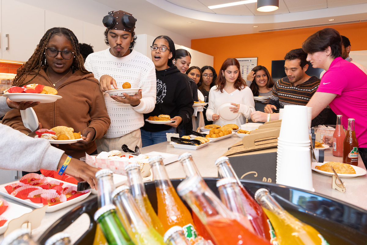 Students lining up to get food from a buffet line.