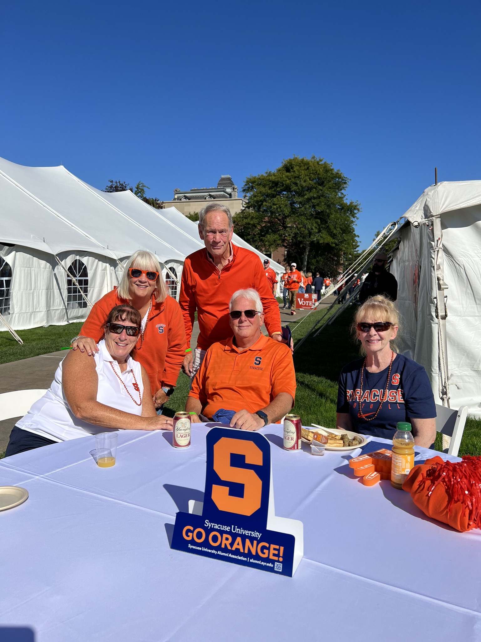 people sitting and standing at a table on the Quad
