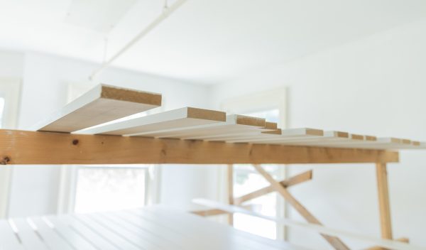 Construction in a room with 2x4 pieces of wood laying down. 