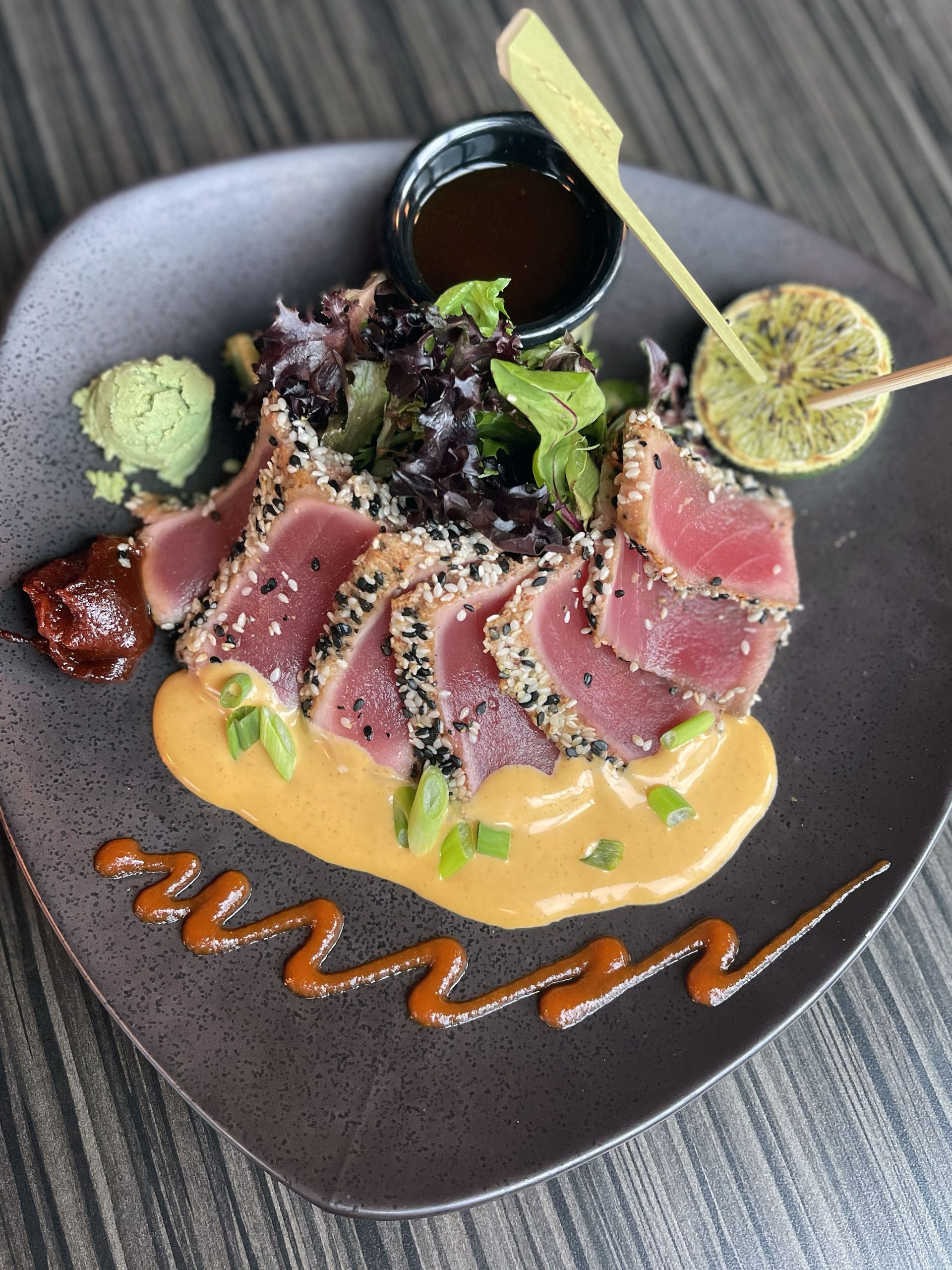 Sesame Seared Ahi on a black plate