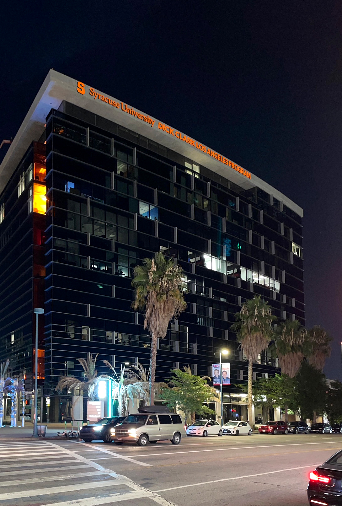 building at night with rendering of wording at top of building Syracuse University Dick Clark Los Angeles Program