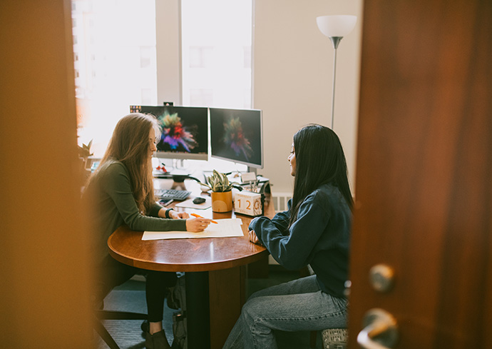 two people sitting at desk