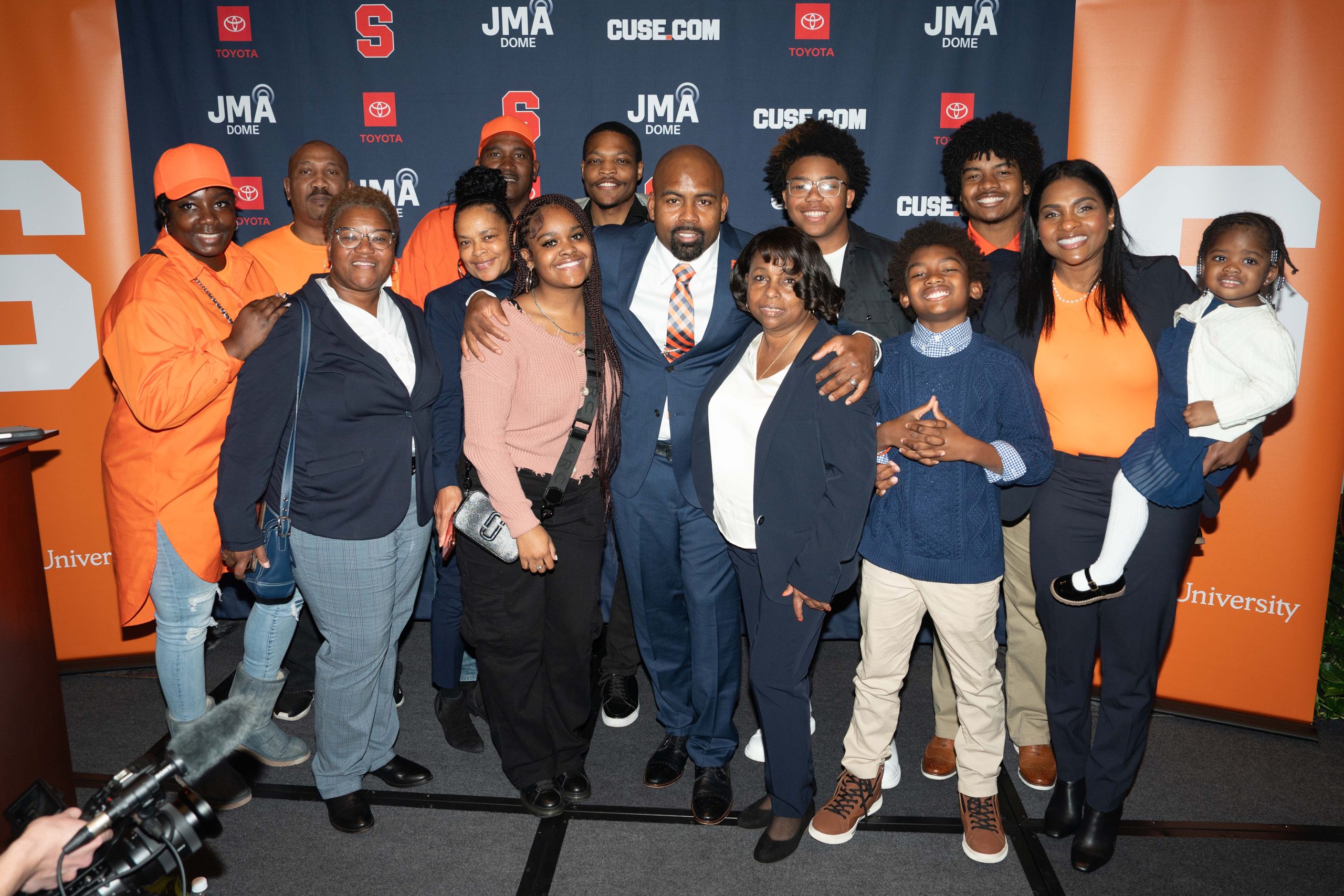 Coach Fran Brown and his family all gather together for a photo at a press conference 