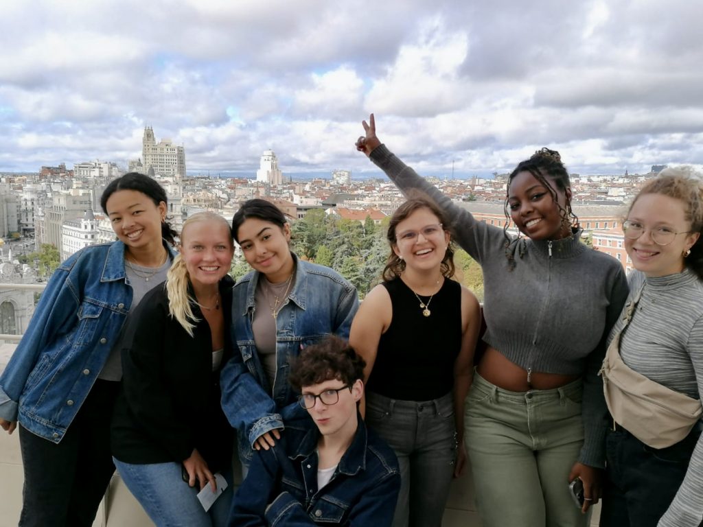 group of people standing above city