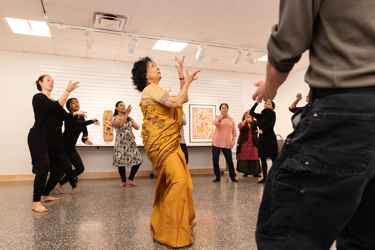 People gathered at the SU Art Museum learning to dance. 