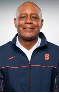 A man smiles for a headshot.
