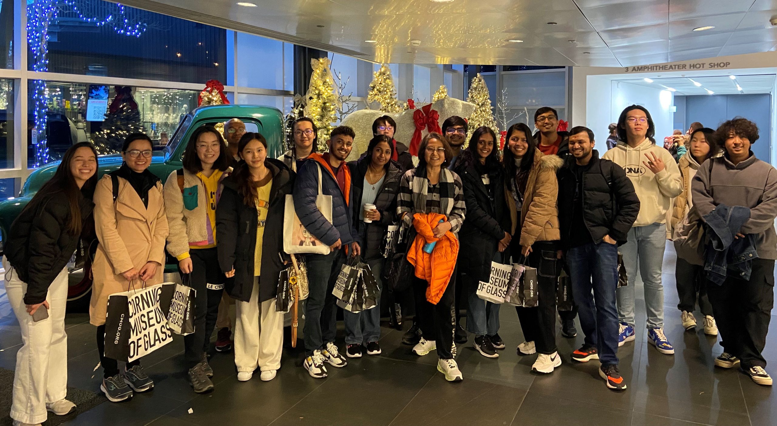 large group of people all standing together smiling for a photo 