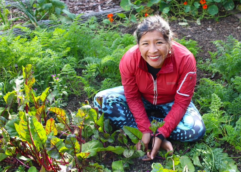Woman smiling sitting in a garden