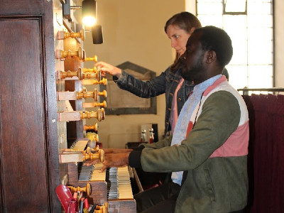 Anne Laver and Joseph Ossei-Little rehearse on the organ at St. Paul's Church in London