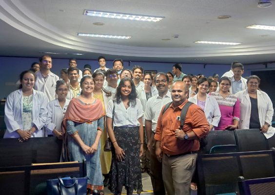 A group of doctors and specialists pose for a photo.