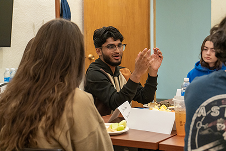 Individual sitting at a table talking