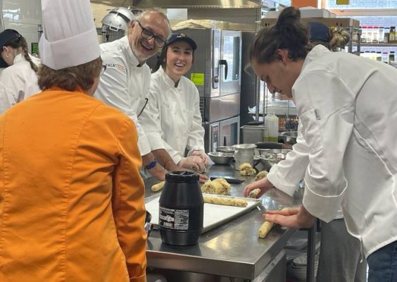 Chef Jacopo Tendi cooking with Falk College nutrition students.