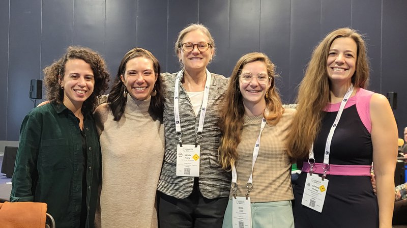 five faculty/alumni pose together at an awards ceremony